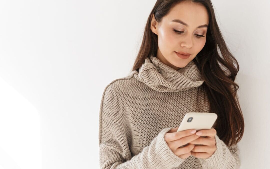 young woman looking at cellphone researching sex after abortion